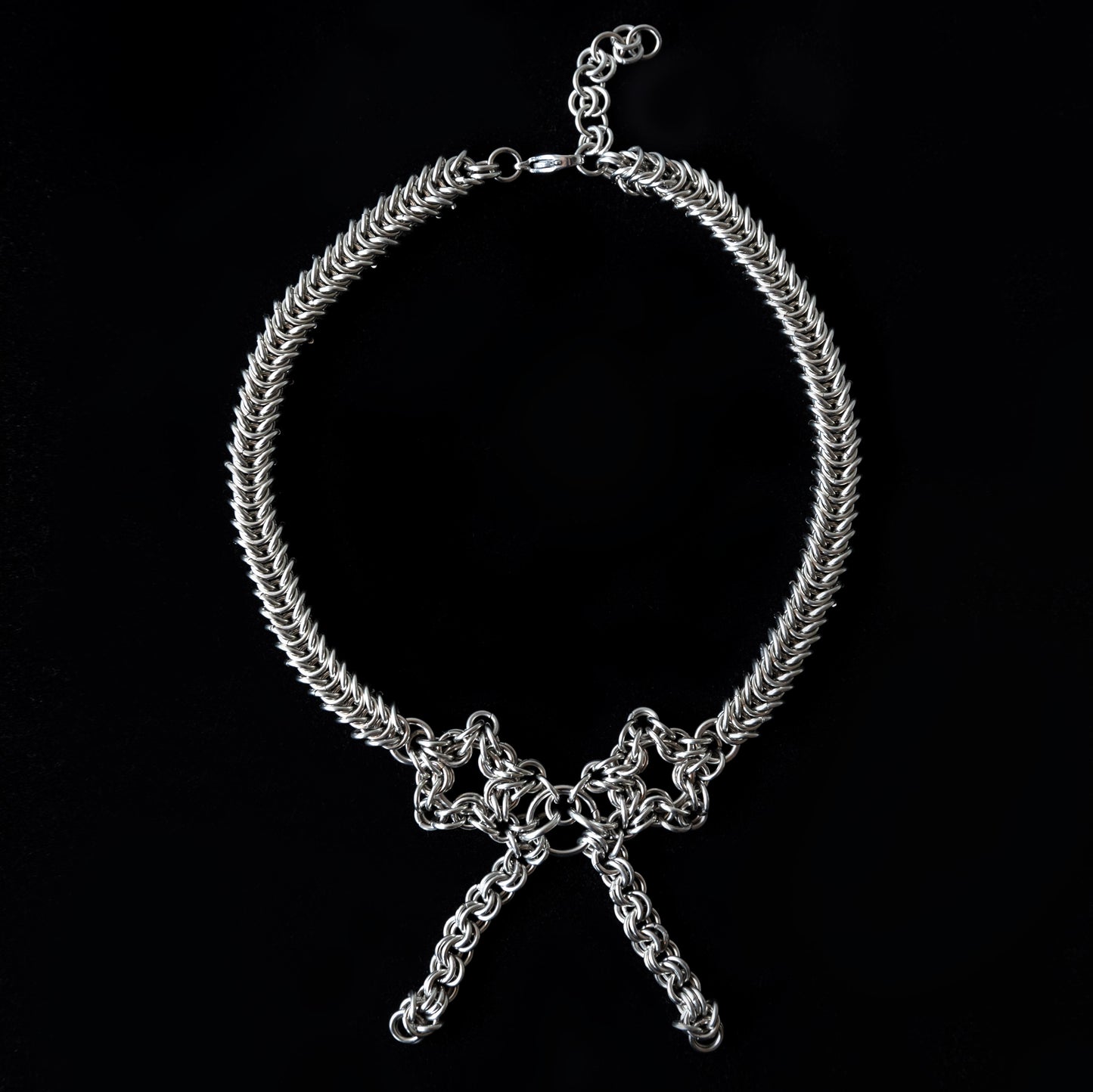 Silver chain choker necklace on a black background