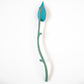 Decorative item with a blue leaf-like structure on a white background
