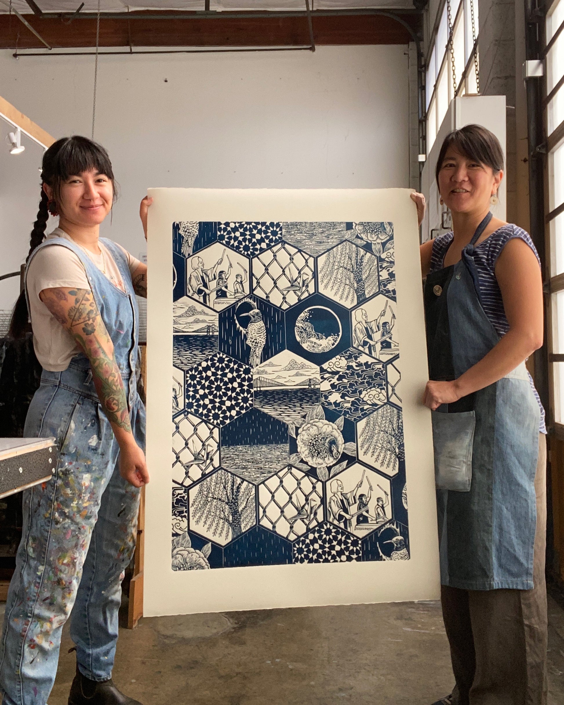 Yoshi and Saiyure holding their print Sound