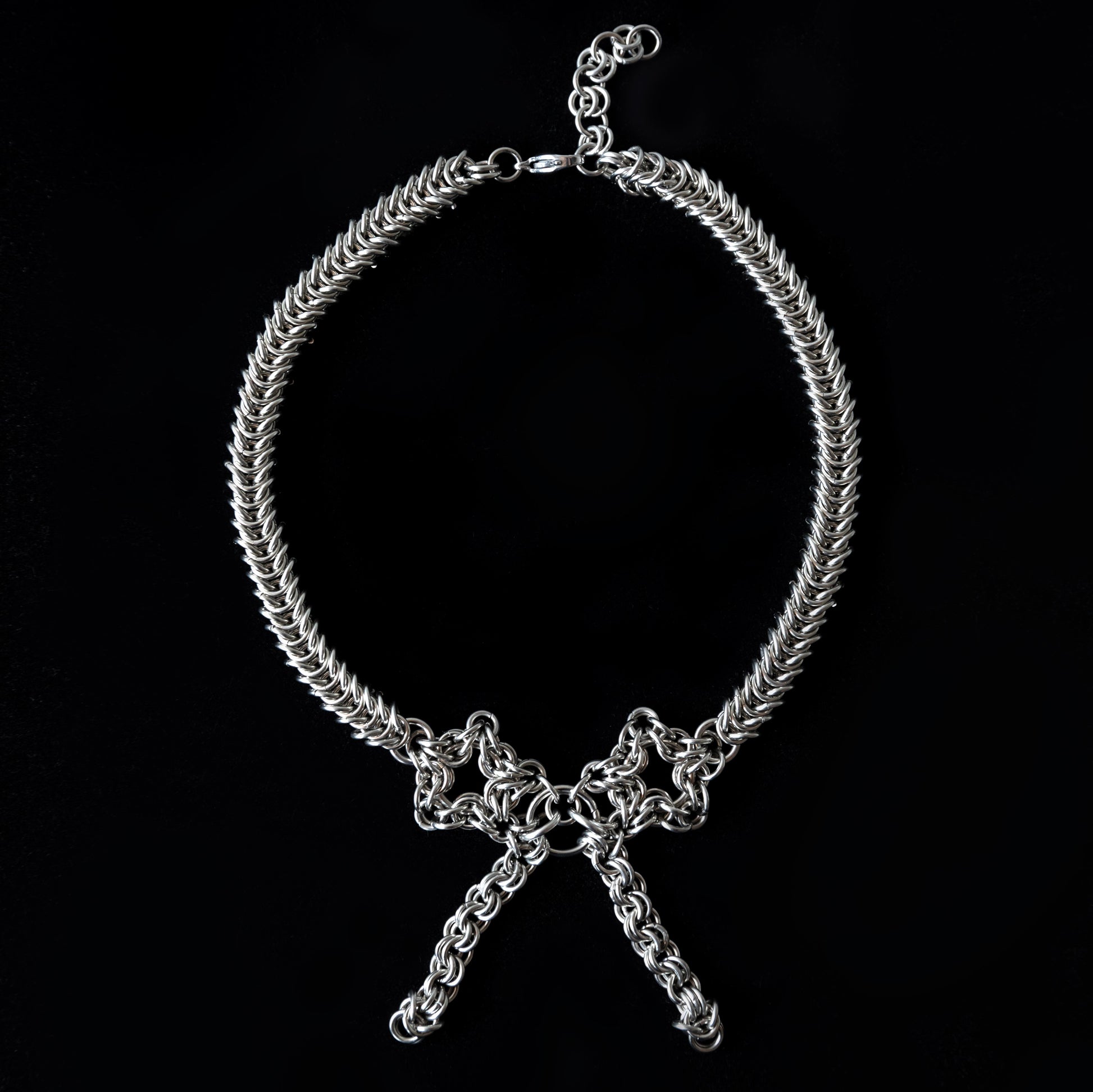 Silver chain choker necklace on a black background