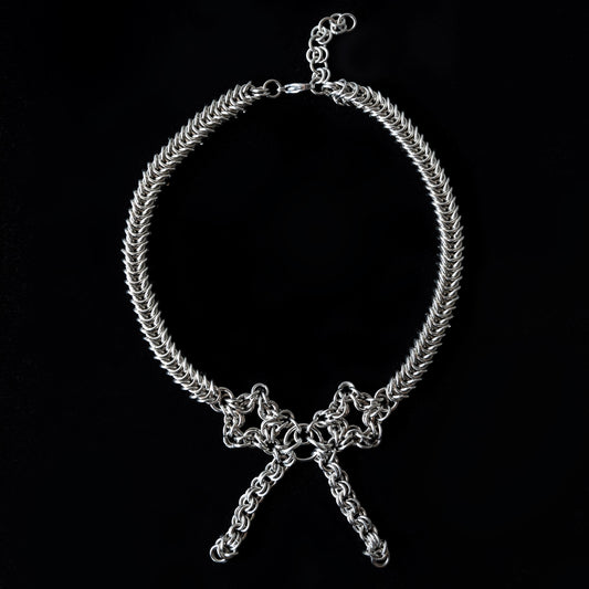 Silver chain choker necklace on a black background